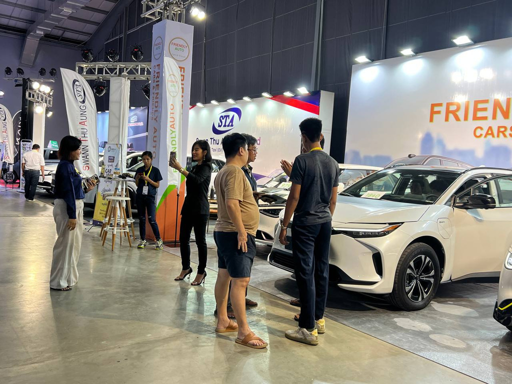 Visitors inspecting vehicles at expo